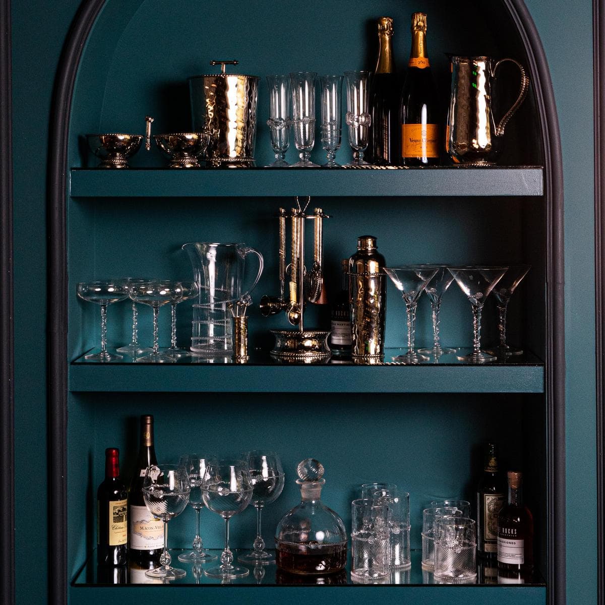 Large shelves in Juliska Teal showcase the metal and glass barware collections.
