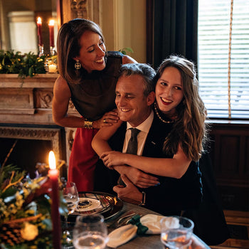 Juliska owner, David Gooding, is embraced by his young daughter and wife at the holiday dinner table.