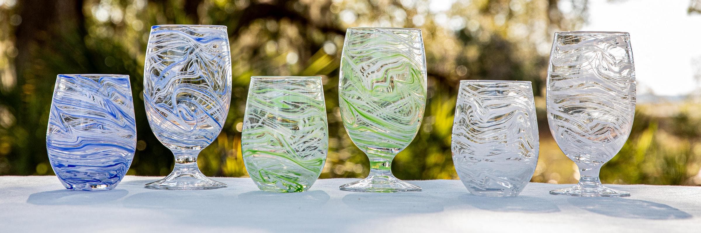 Set of Puro Marbled glasses on a table outdoors.