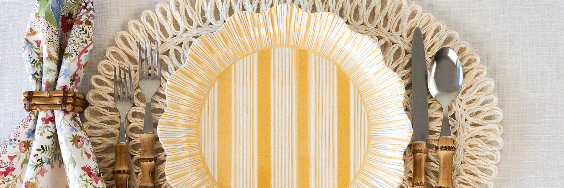 Moveable gif featuring different melamine plates from cabana, berry & thread, and sofia on a rattan placemat.  Bamboo flatware and napkin ring is also featured.