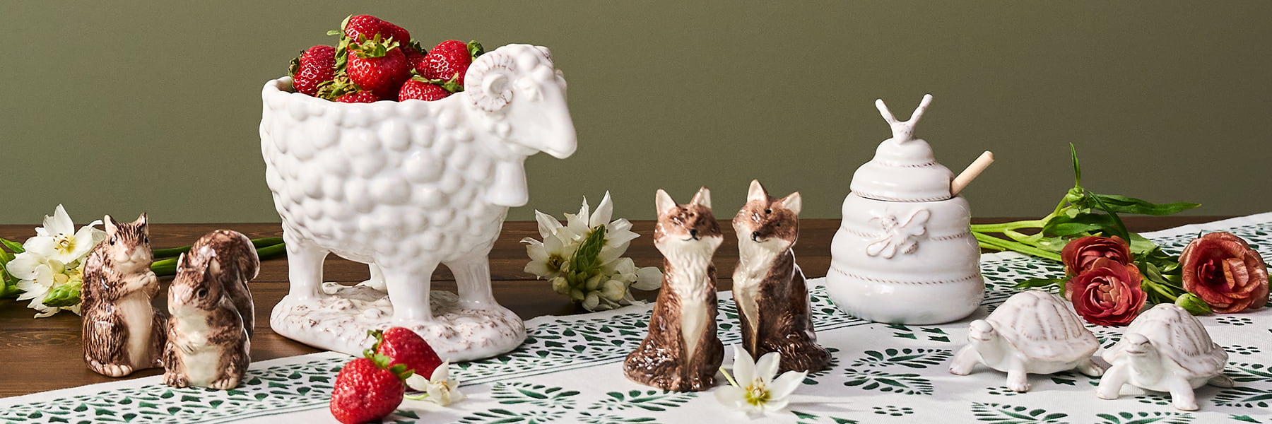 Whimsical vases mixed in with other ceramic pitchers and planters.