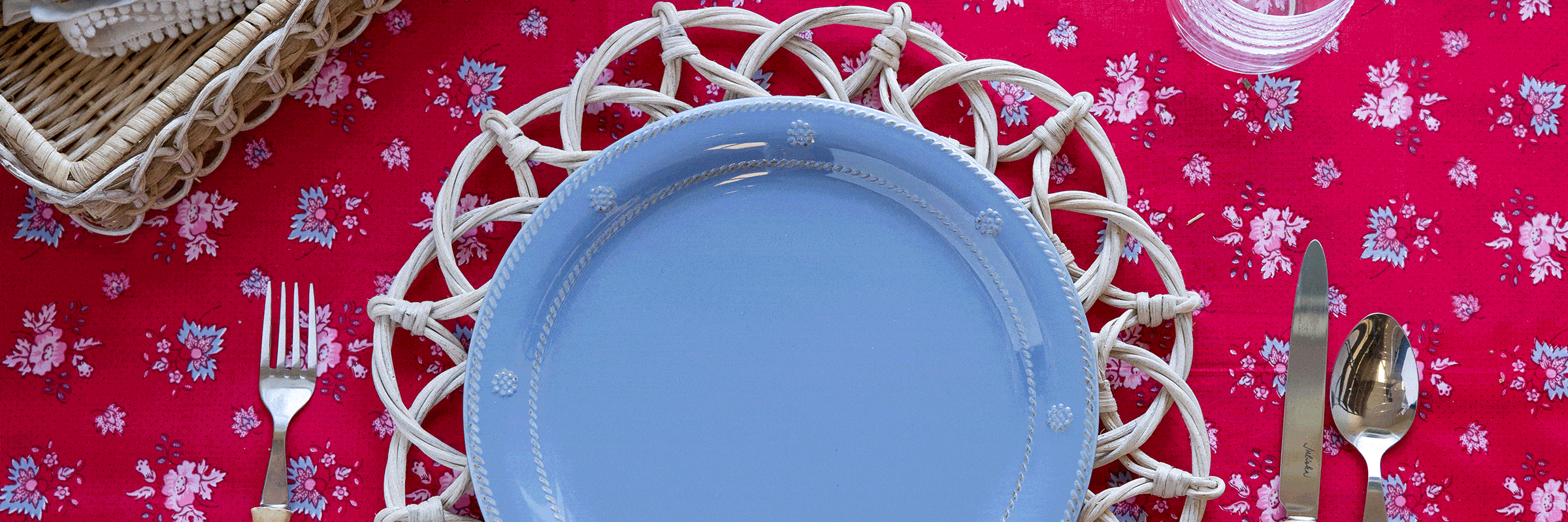 Melamine dinner plates in white and blue on a red tablecloth