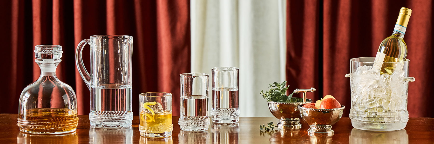 Dean decanter, pitcher, glasses and ice bucket on a wooden surface