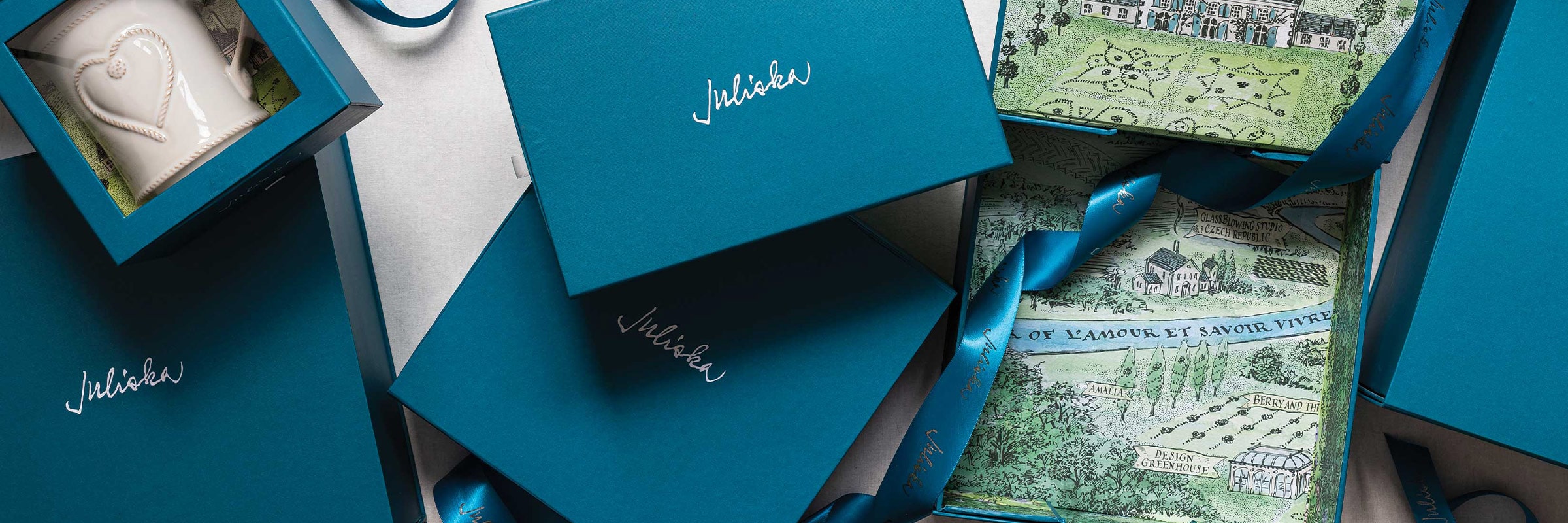 Teal gift boxes with Juliska logo on them.