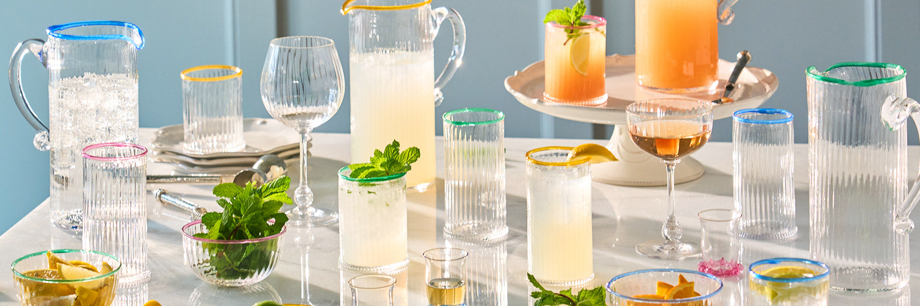 Image featuring Nell drinkware and pitchers filled with beverages on a table