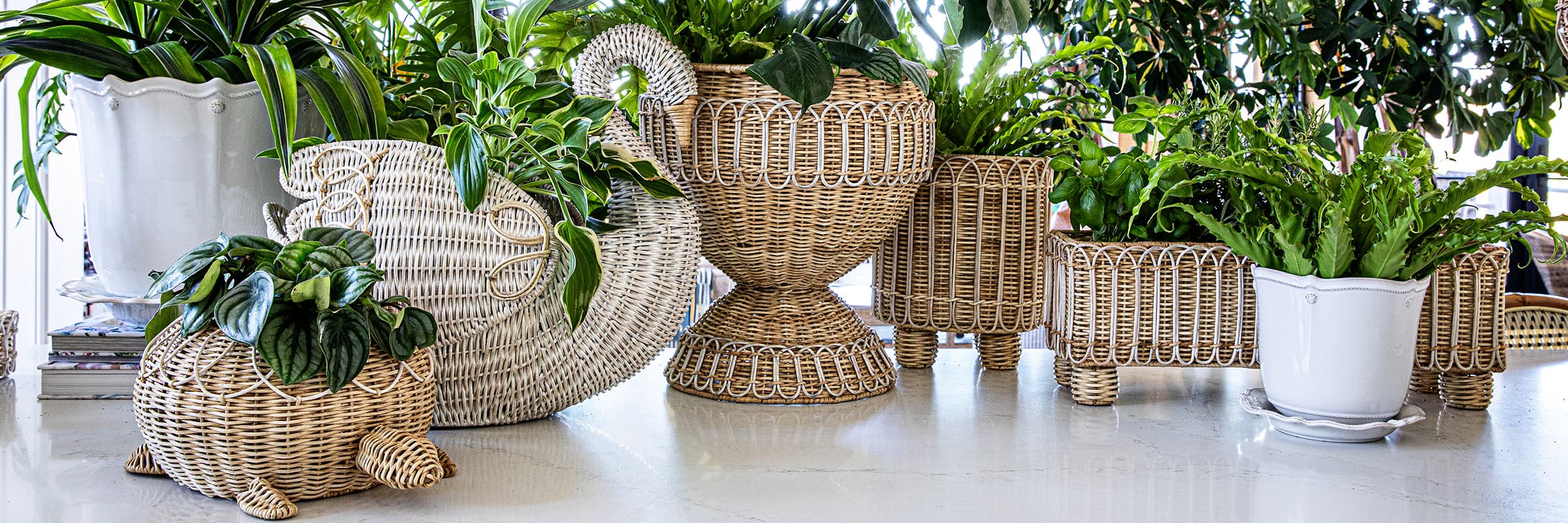 Provence rattan baskets filled with greenery displayed on a porch