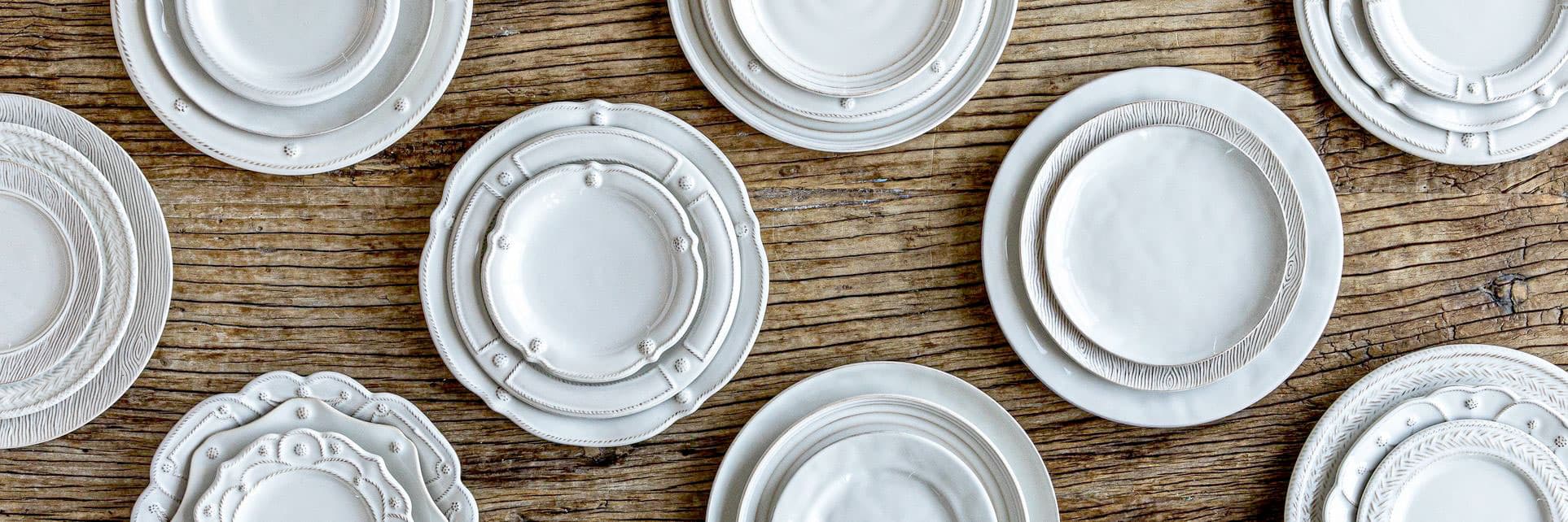 Juliska whitewash place settings on a rustic wood table.