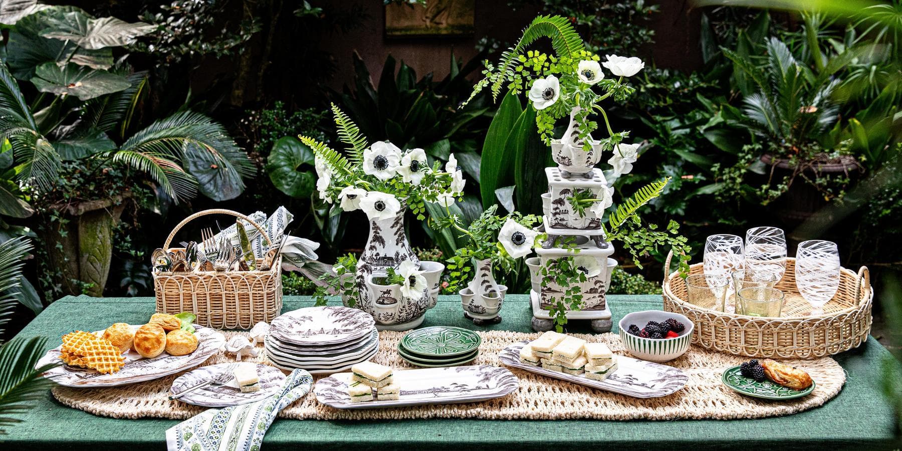 Country Estate flint tulipiere vases alongside country estate plates and trays on an outdoor table.