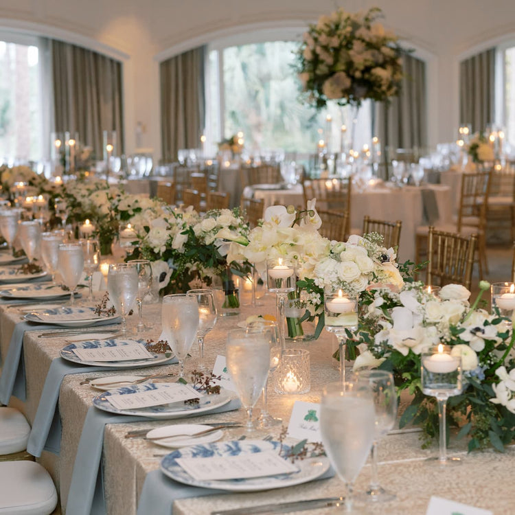 A photograph of a wedding table set with the couple's wedding registry plates - Country Estate in Delft Blue