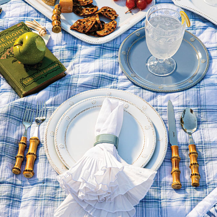 White and Chambray Melamine dinner plates on a picnic blanket.