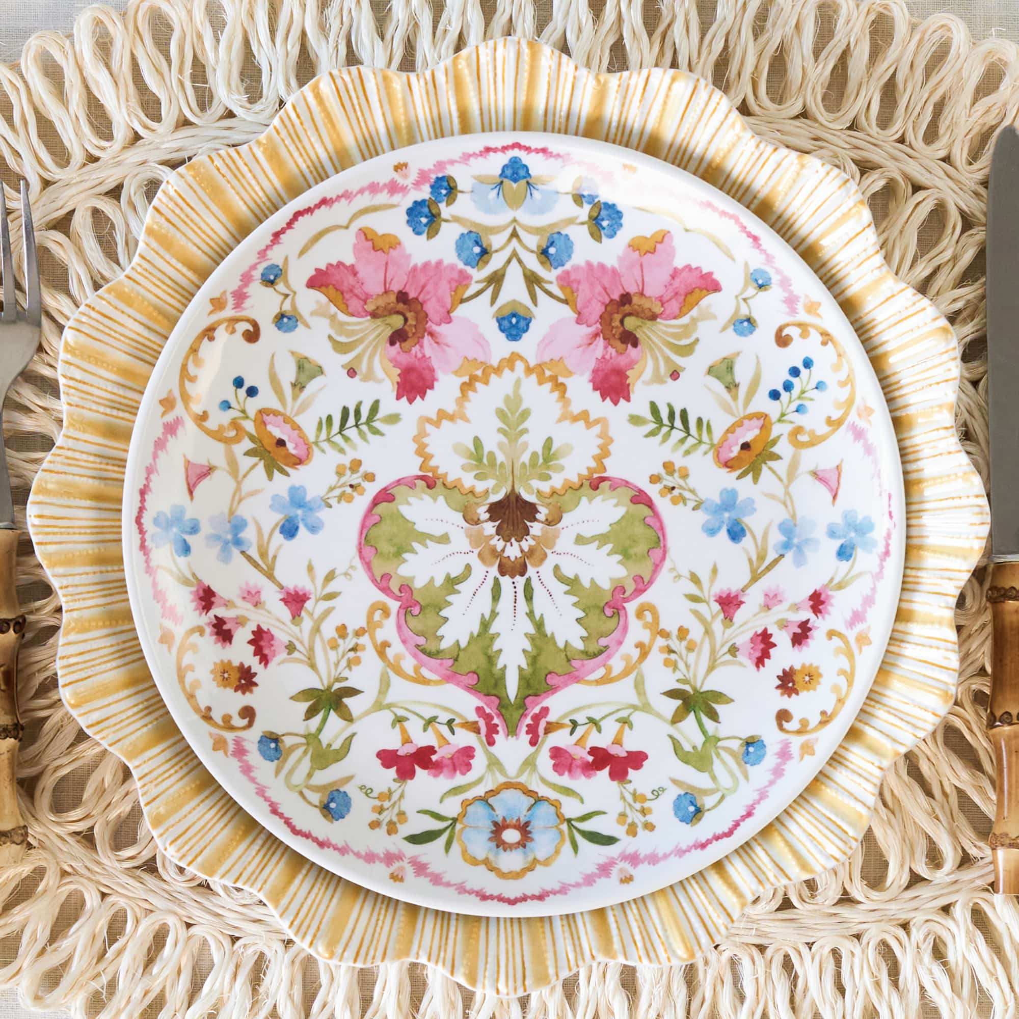 Image of melamine cabana yellow dinner plate and sofia melanine plate on a rattan placemat