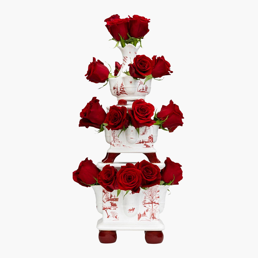 Three-tiered white floral stand with red roses on a white background