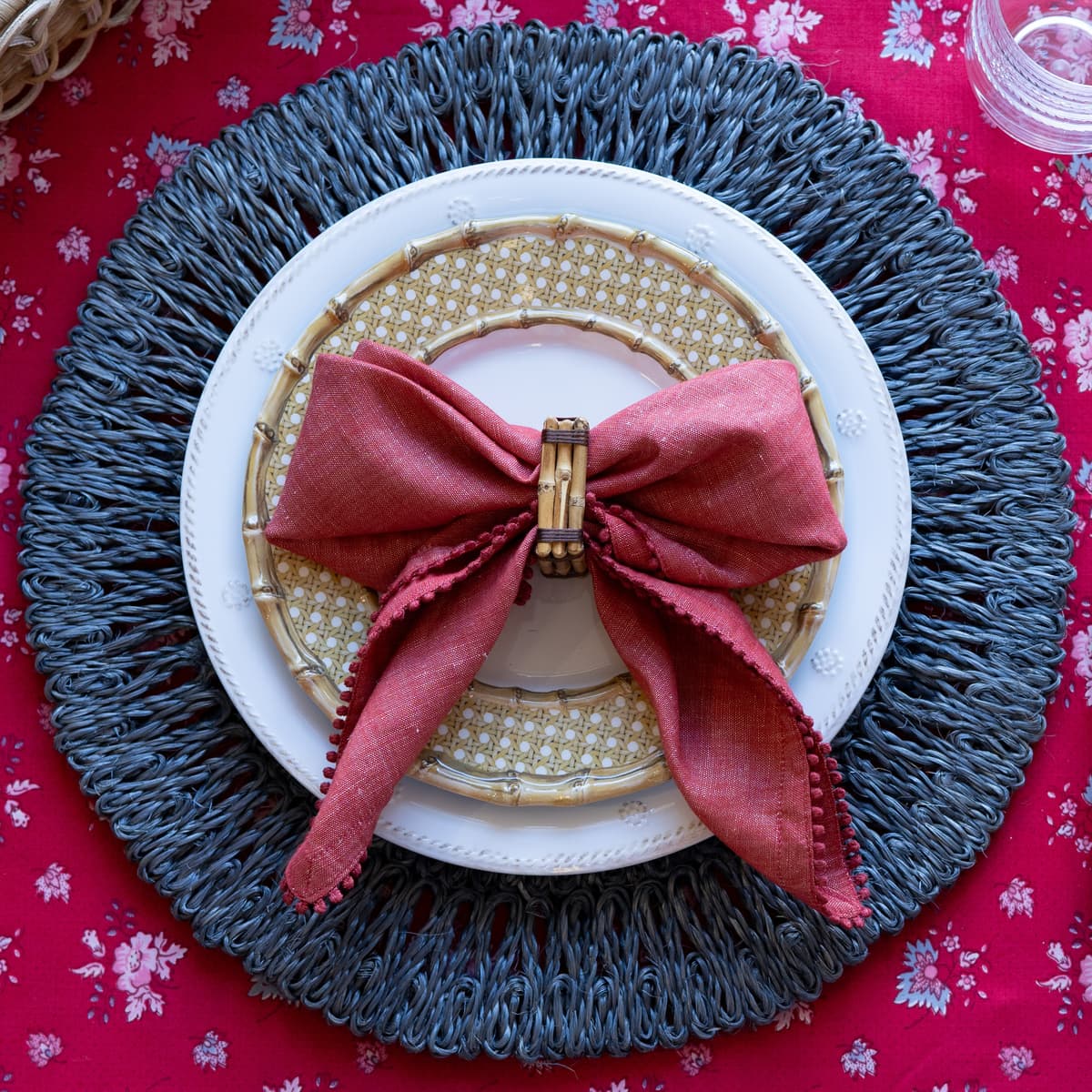 Melamine dinner plates stacked on a blue rattan placemat