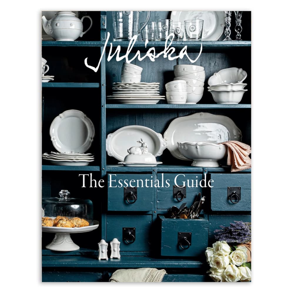 Book cover of 'Juliska The Essentials Guide' with kitchenware on shelves.
