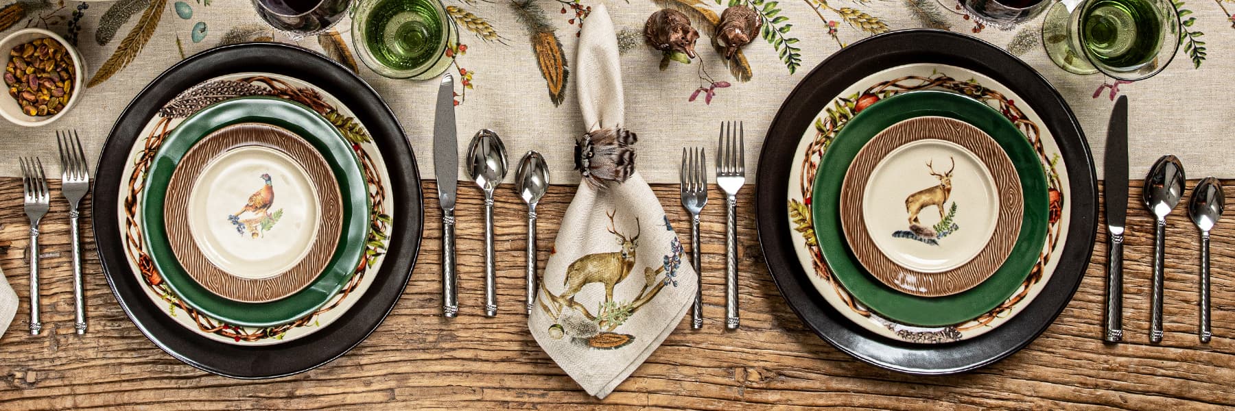 Forest walk plates stacked on a table runner with graham flatware
