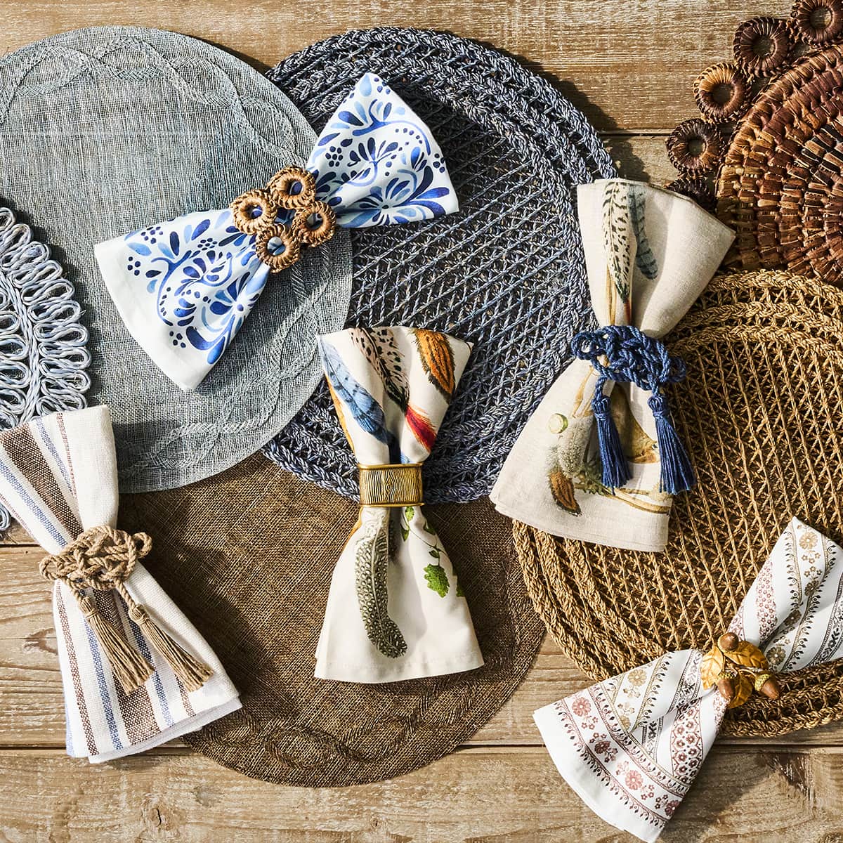 Five folded napkins laid out on top of placemats