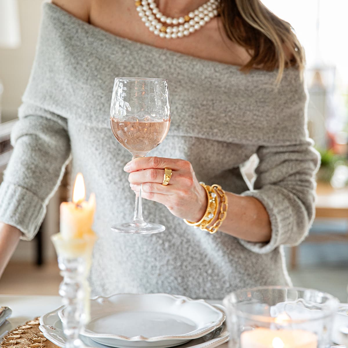 Woman modeling Capucine De Wulf jewelry holding puro wine glass