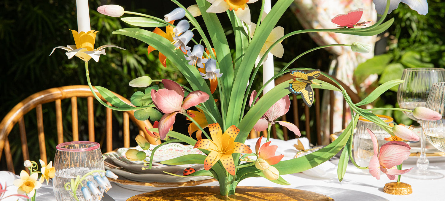 Decorative floral centerpiece on a table with a garden setting