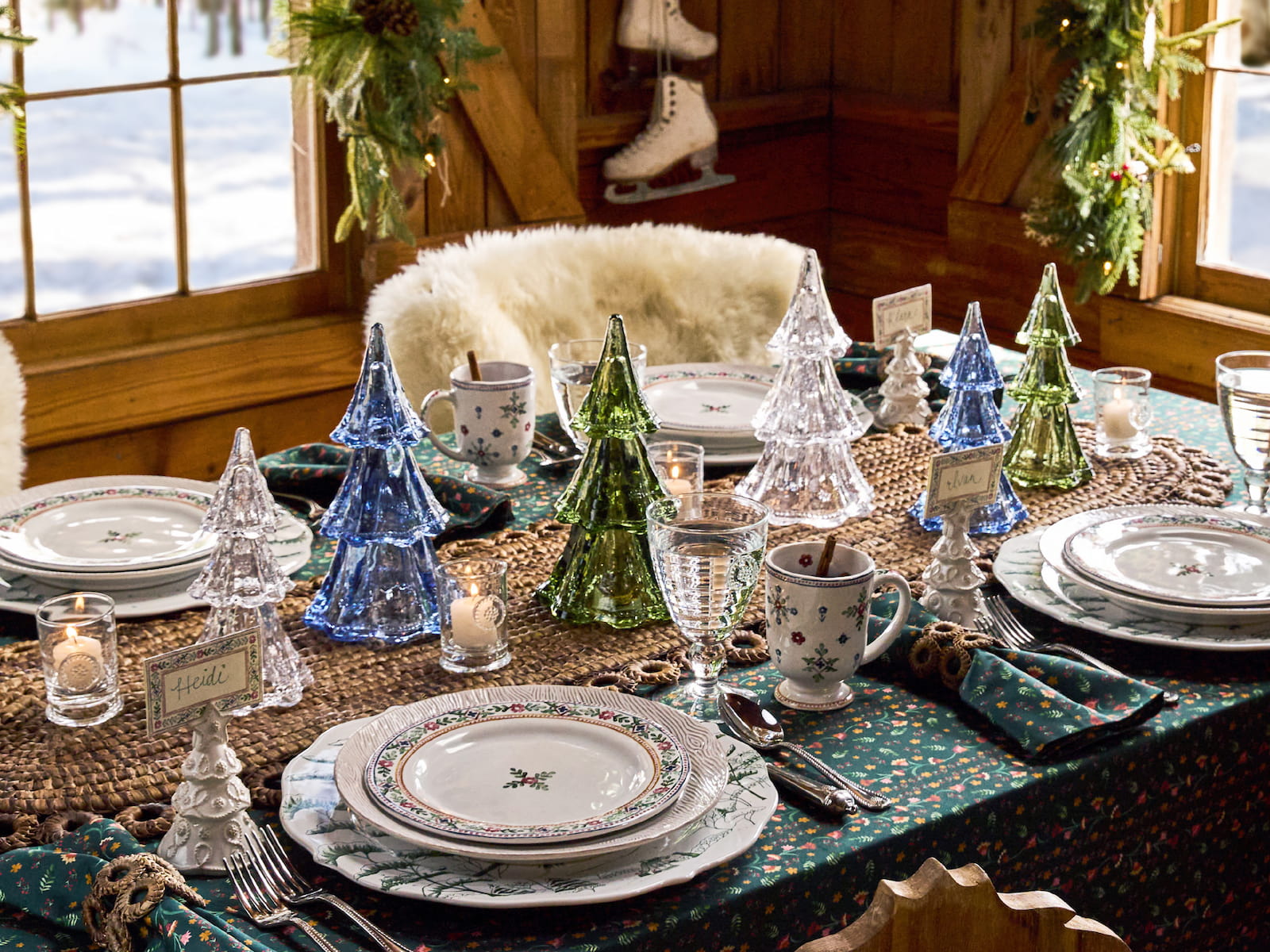 Decorative Christmas table setting with glass trees and patterned tablecloth.