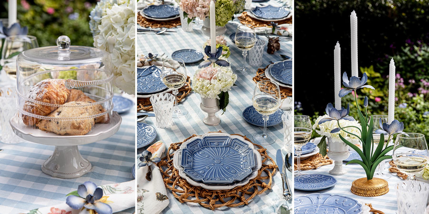 Table setting with blue plates, white flowers, and candles in an outdoor garden.
