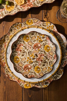 Decorative ceramic plate with floral patterns on a wooden surface
