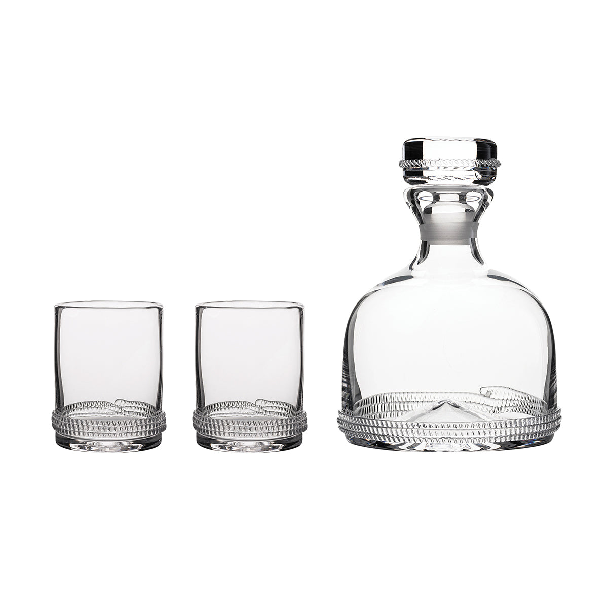 Equal parts streamlined and sturdy, debonaire and distinctive, the Dean decanter and pair of Double Old Fashioned glasses is the quintessential wind down after a long day on the range or on the road. Subtle glass rope detailing encircles the base to capture the perfect amount of sparkle to make an occasion of every day, alongside clinking ice, hefty pours, and witty toasts. Handsomely packaged in our signature Juliska gift box.