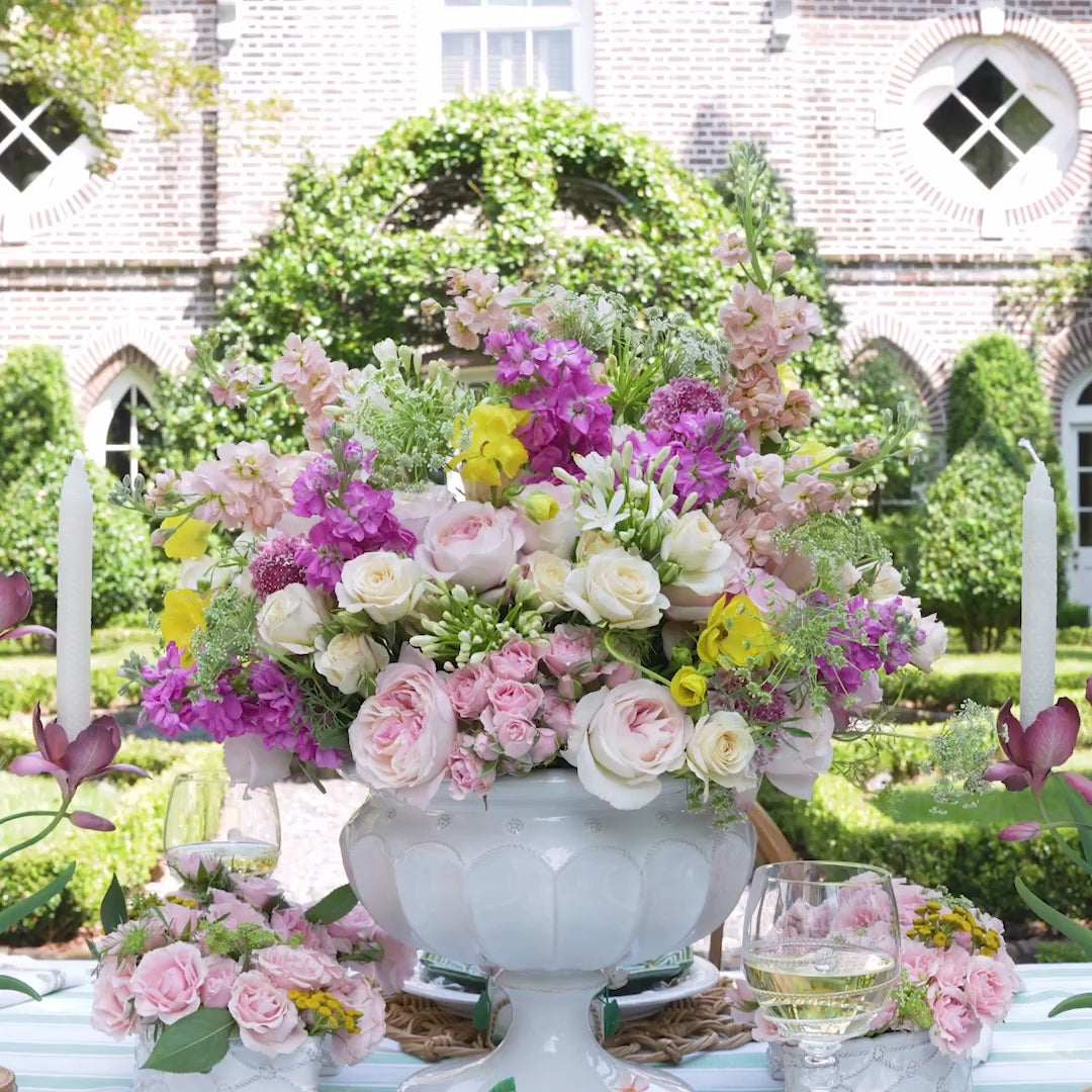 Load video: Video of elegant table setting with woven placemats, plates, and cutlery on a light surface.