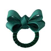 Our new tuxedo-inspired napkin ring was designed in an elegant evergreen hue to dress up any Holiday place setting. Handsewn with rings wrapped in soft velvet ribbon, these handsome green bows will festoon any table with festive flair.