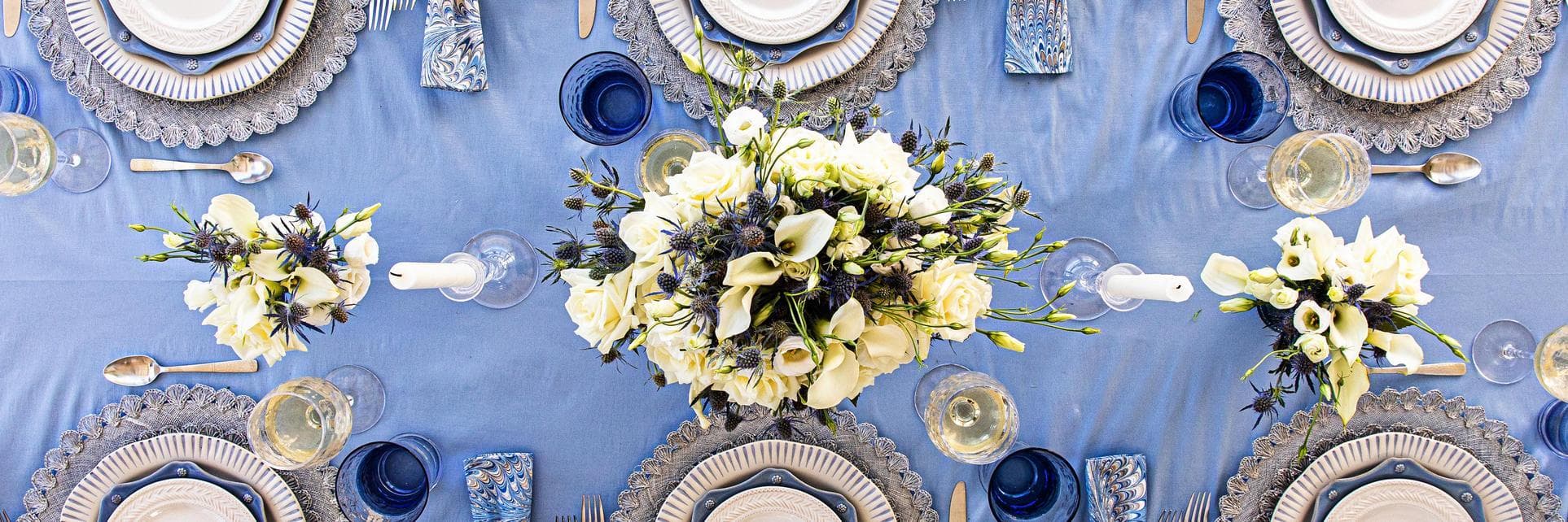 Blue and white tablescape with white flowers.