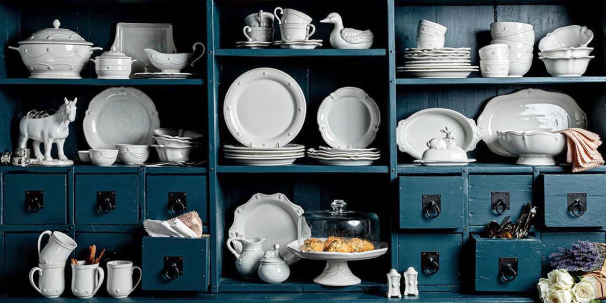 Berry & Thread Whitewash Collection in a blue cabinet.