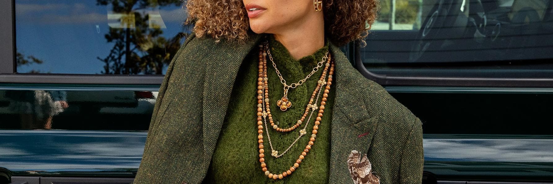 Capucine De Wulf Jewelry Banner - woman wearing green outfit with teak jewelry