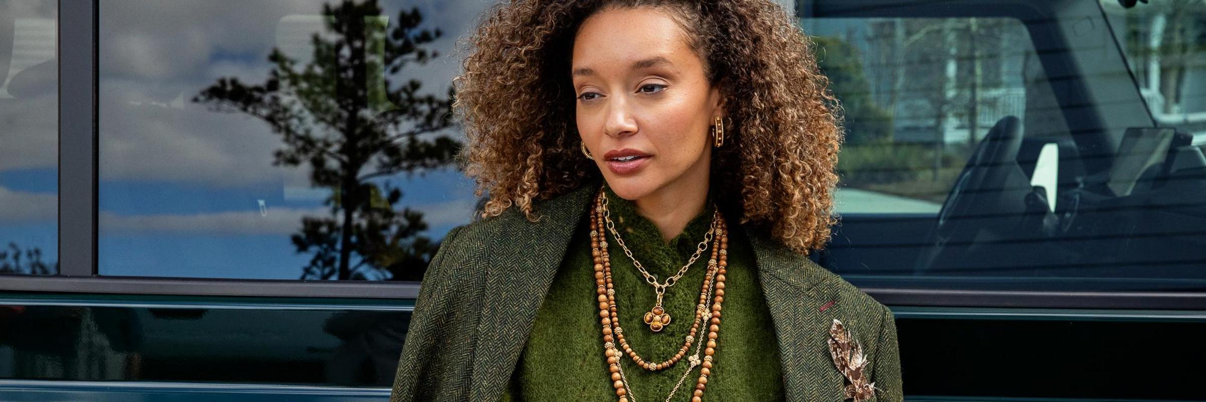 Capucine De Wulf Jewelry Banner - woman wearing green outfit with teak jewelry