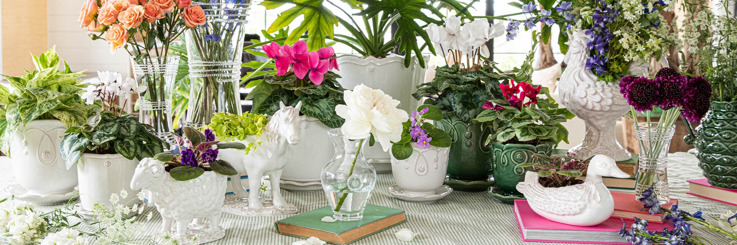 Whimsical Clever Creatures and beautiful vases are filled with colorful flowers.