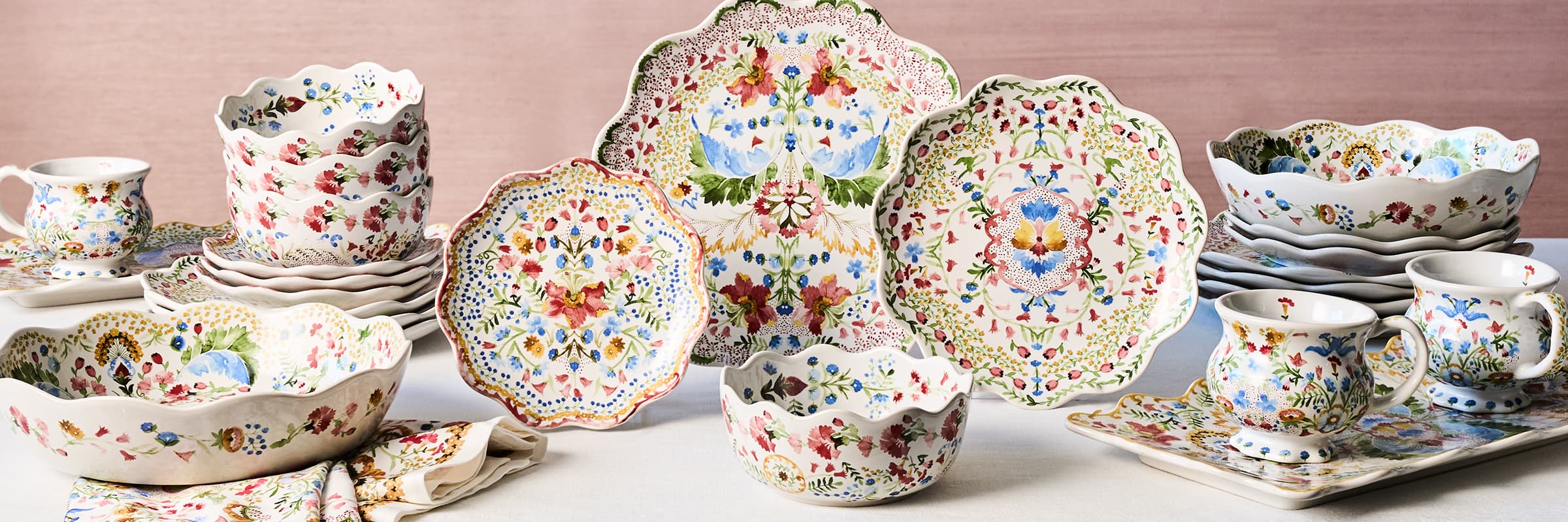 Juliska Sofia plates and napkin on top of a green rattan placemat