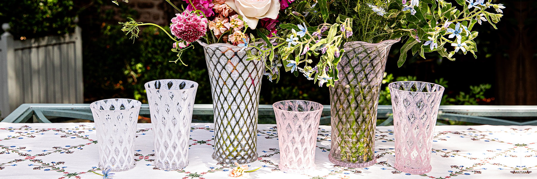 Juliska "Trellis" white and blush vases displayed with flowers in them