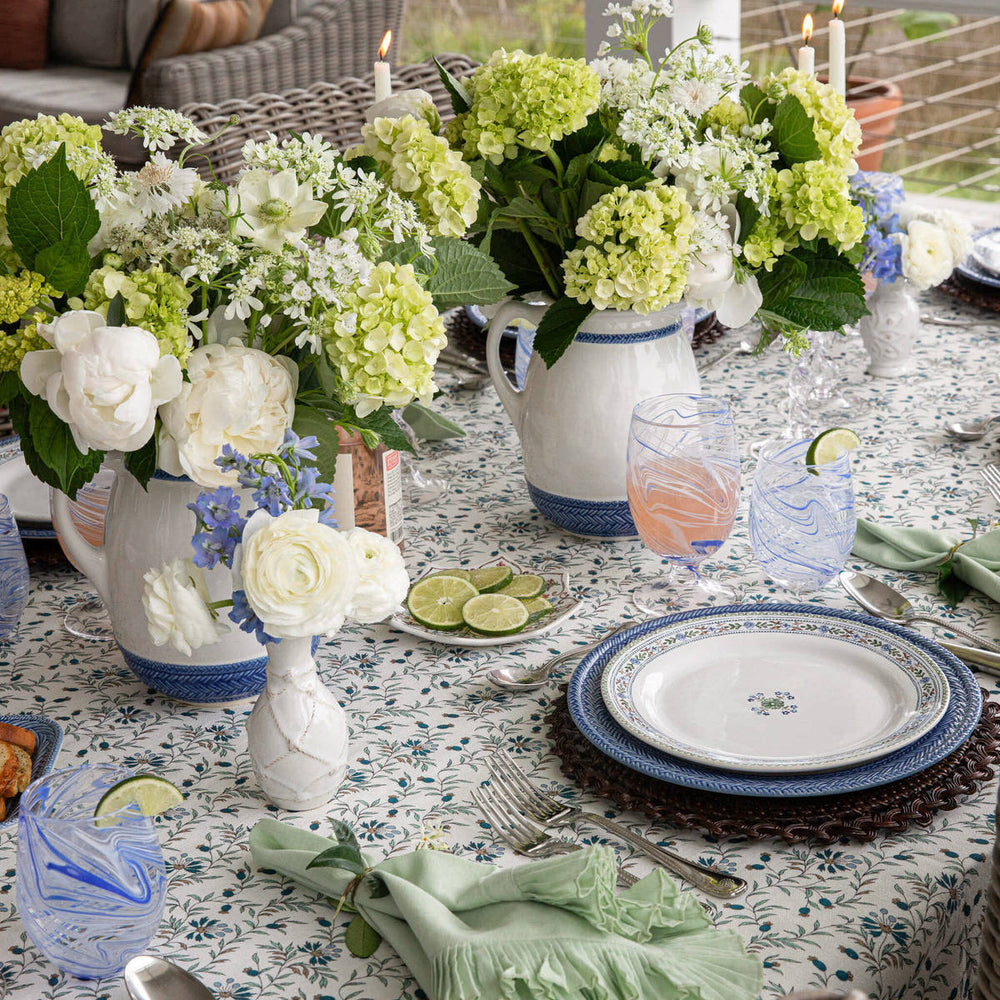 Image depicts le panier and villa seville plates amongst a floral tablescape