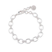 A silver link bracelet featuring alternating polished oval links and textured barrel links, with a lobster clasp and a round branded tag, shown on a plain white background.