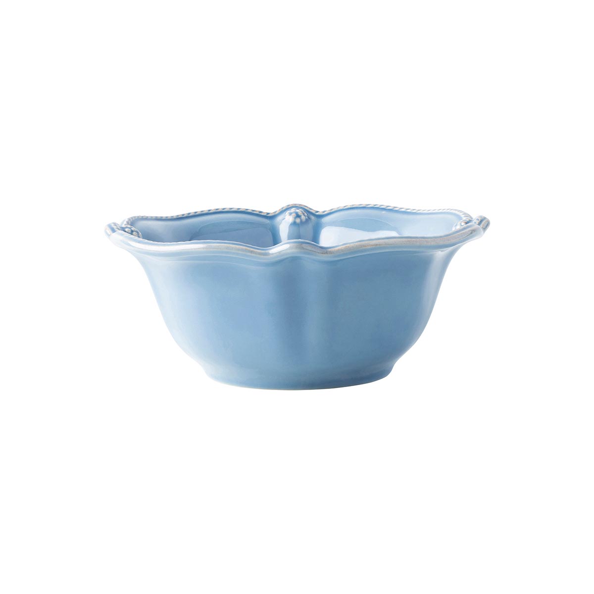 This whitewashed cereal bowl is rimmed with a simple thread and adorned with a sprinkling of berries.