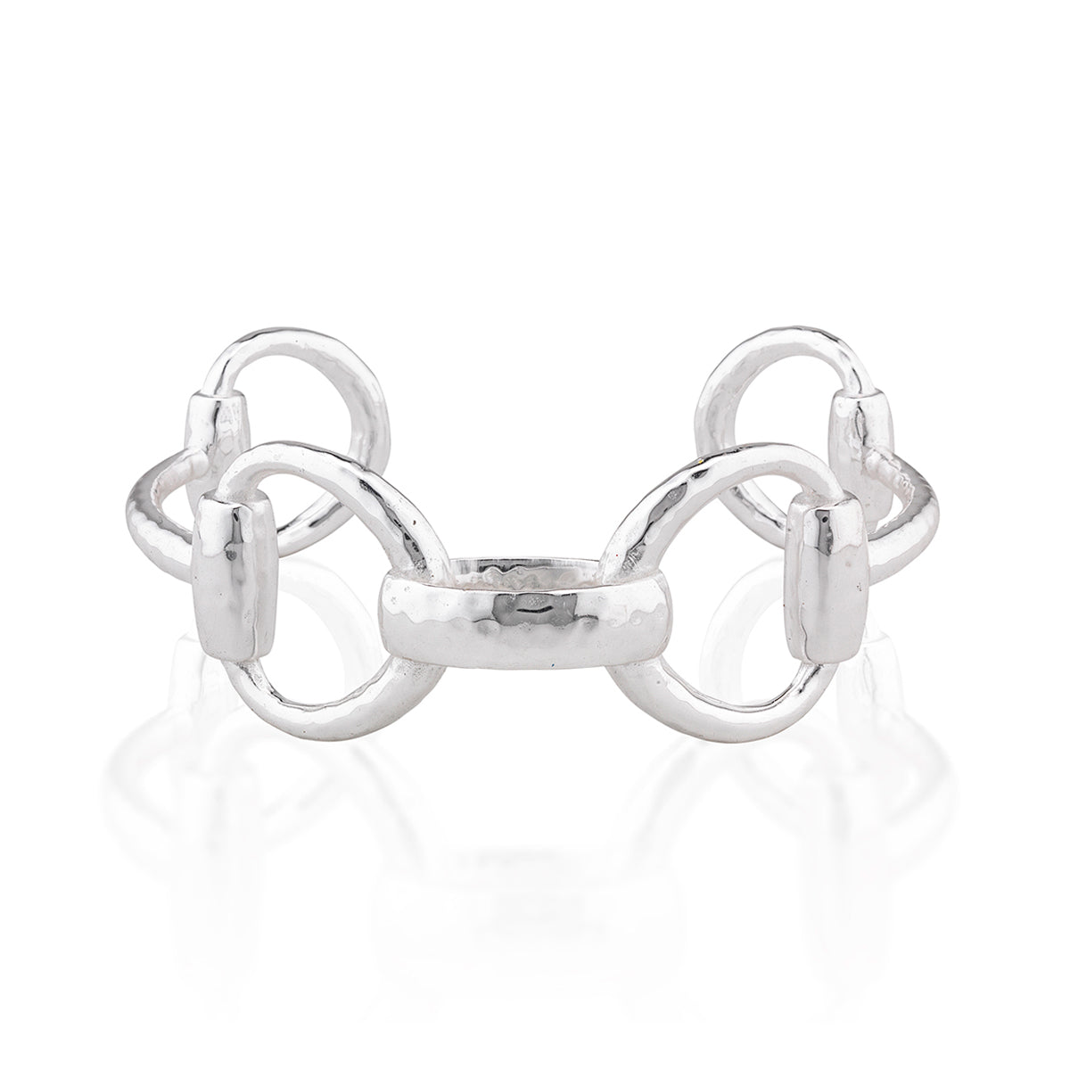A polished silver cuff featuring a central textured bar flanked by two interlocking circular loops, displayed on a clean white reflective surface.