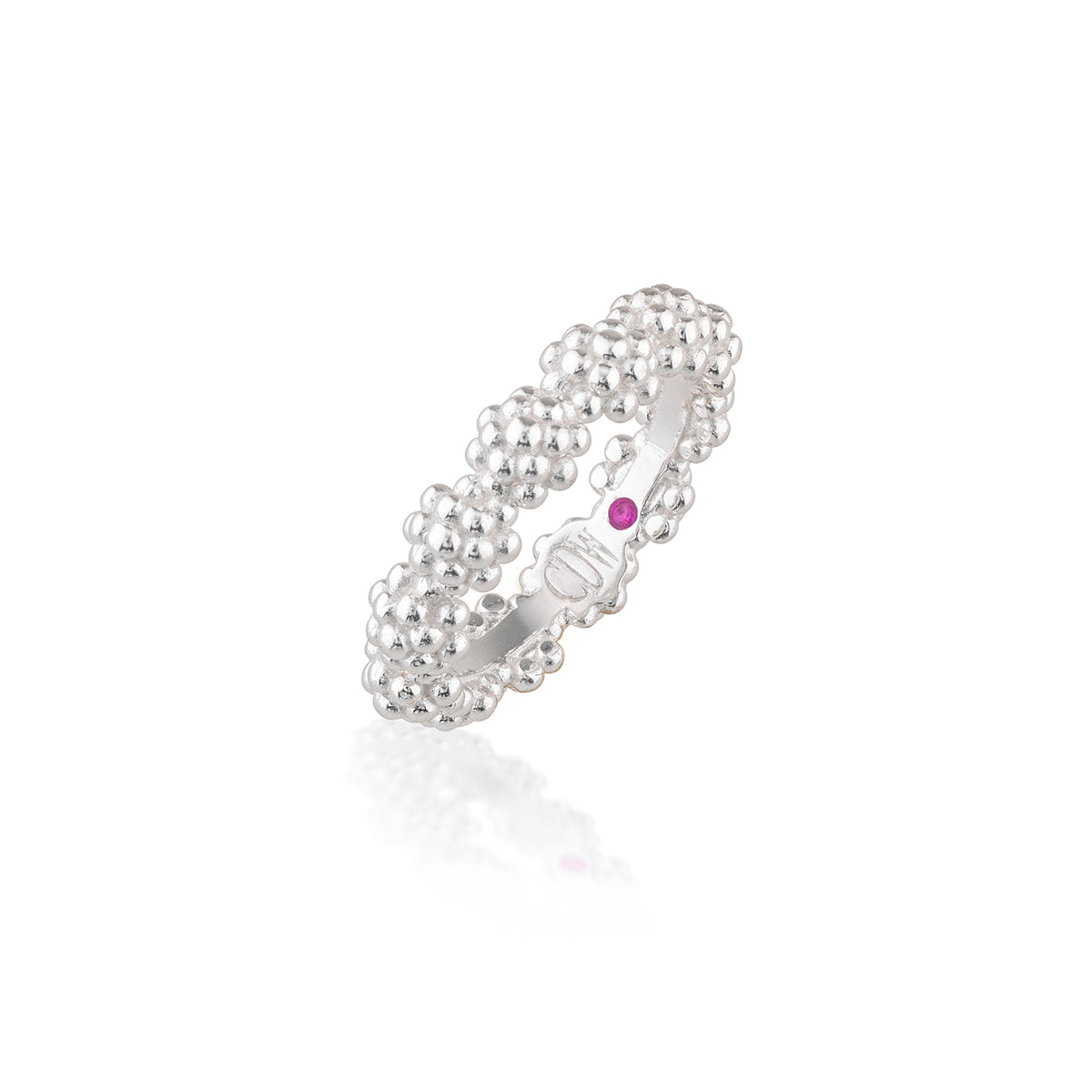 A silver beaded band ring with a small round purple gemstone on the side, displayed on a clean white background with a soft reflection.