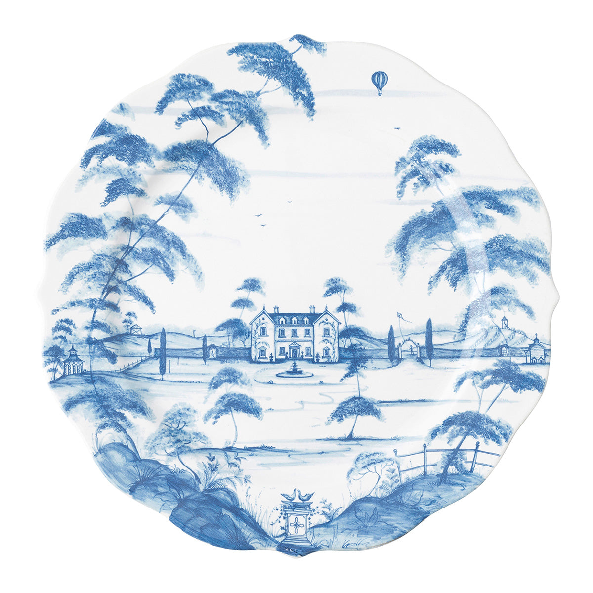 A white plate with a painted blue design of a country estate.