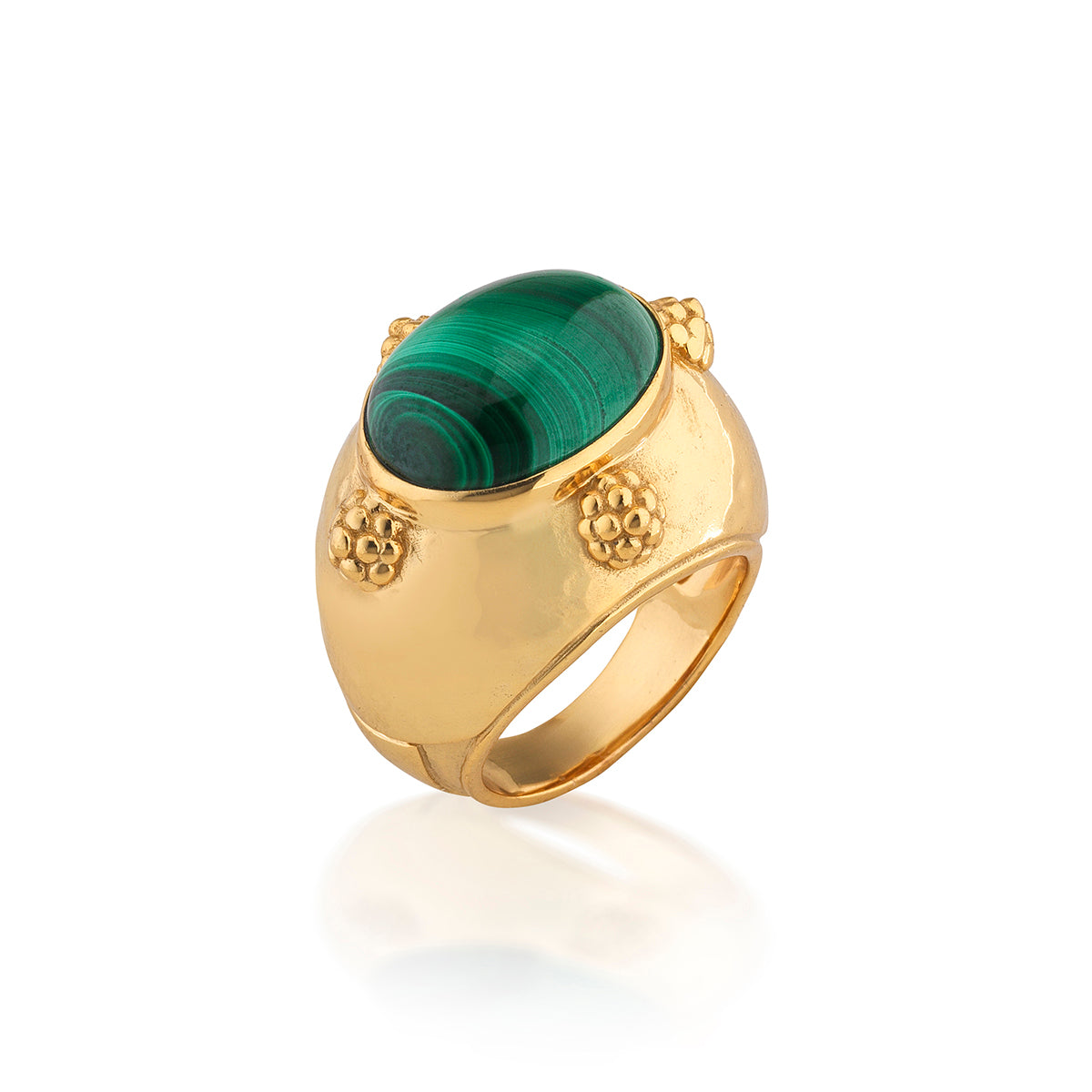 A gold ring featuring a large oval green malachite stone in a textured bezel setting, shown on a clean white background with a soft reflection.