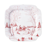 A 12" white tray with red artwork of Santa and his elves preparing his sleigh.