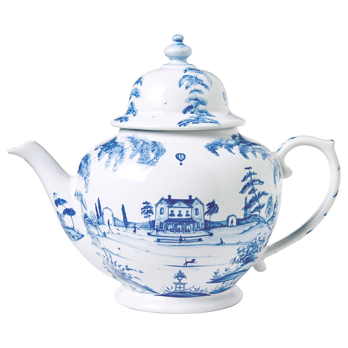 A white teapot with a blue design painted on it of a country estate.