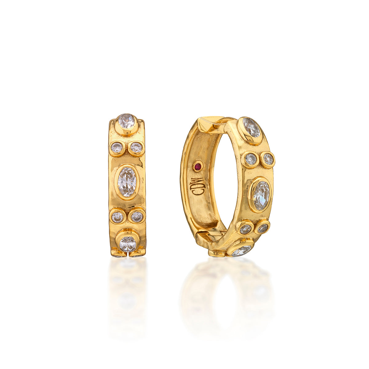 Gold hoop earrings with embedded stones on a white background