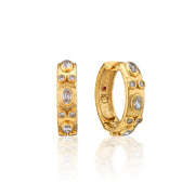 Gold hoop earrings with embedded stones on a white background