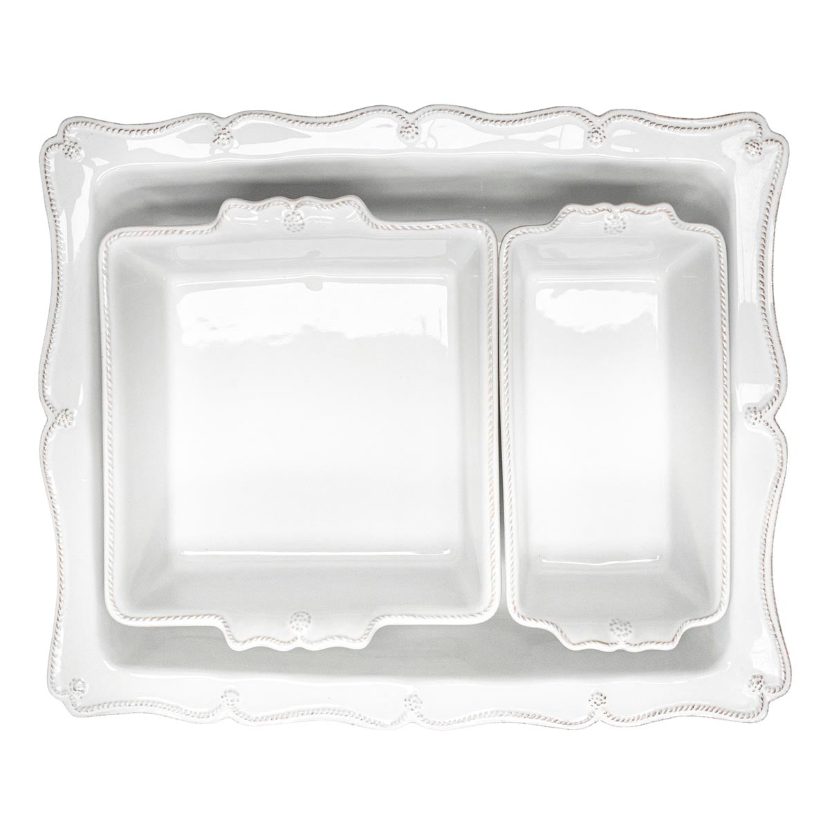 This space-efficient nesting trio is a triumph for home bakers! Practical and pretty, our oversized 17” rectangular baker features a beautiful scalloped edge reminiscent of a ruffled apron, and can snugly accommodate our loaf pan (Baker? Loaf baker? Need to keep consistent) and square baker, to easily fit all three together in your cupboard. Perfect for beloved holiday recipes and for feeding a crowd -- and those lovely handles make taking these dishes from the oven to the table…and easy as pie!