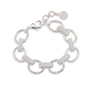 A silver link bracelet featuring alternating smooth oval links and textured rope-style links, with a lobster clasp and a small round charm, shown on a plain white background.