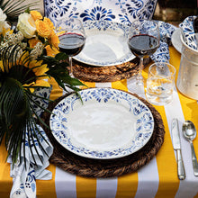 Iberian Indigo plates and linens on a yellow and white stripped tablecloth
