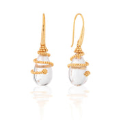 Gold earrings with clear teardrop-shaped stones on a white background